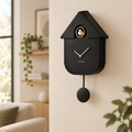 Black Karlsson cuckoo clock on a modern home wall
