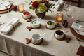 Ceramic ramekins on fish-shaped acacia boards styled for a dinner party