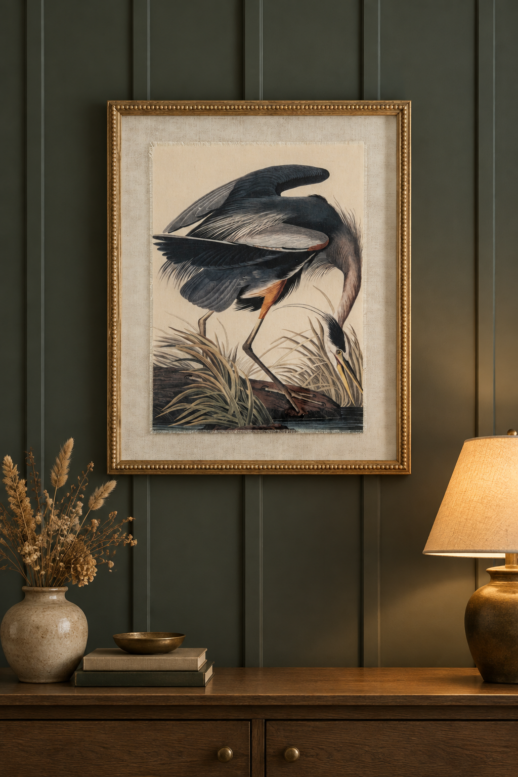 Heron framed print hung on a deep moody panelled wall above a console table