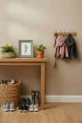 Sage green frame and ceramic floral bowl on console table in family hallway
