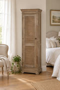 Tall louvre shutter cabinet in a bedroom with oak wooden flooring